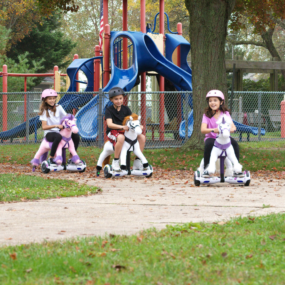 3 kids riding power ponies in the park